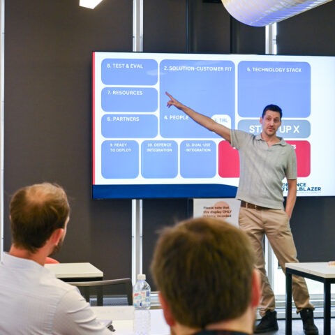 man points to screen with slide show